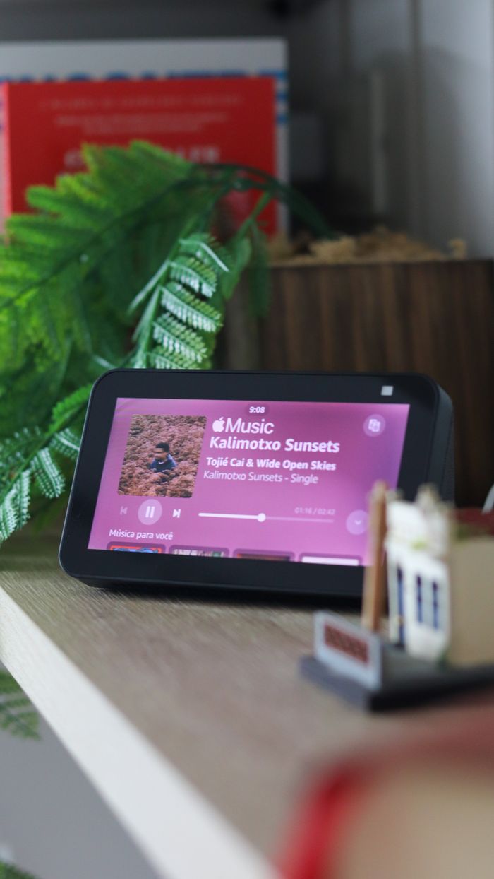 about-01 A smart device on a table displaying a music app interface indoors.